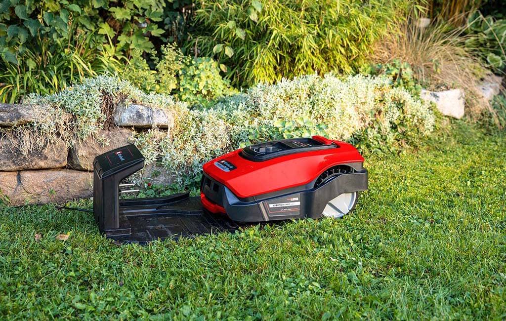 A robotic lawnmower driving into the charging station to recharge.