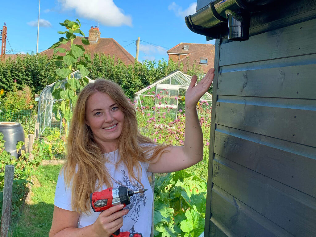 Woman presenting the installed water gutter.