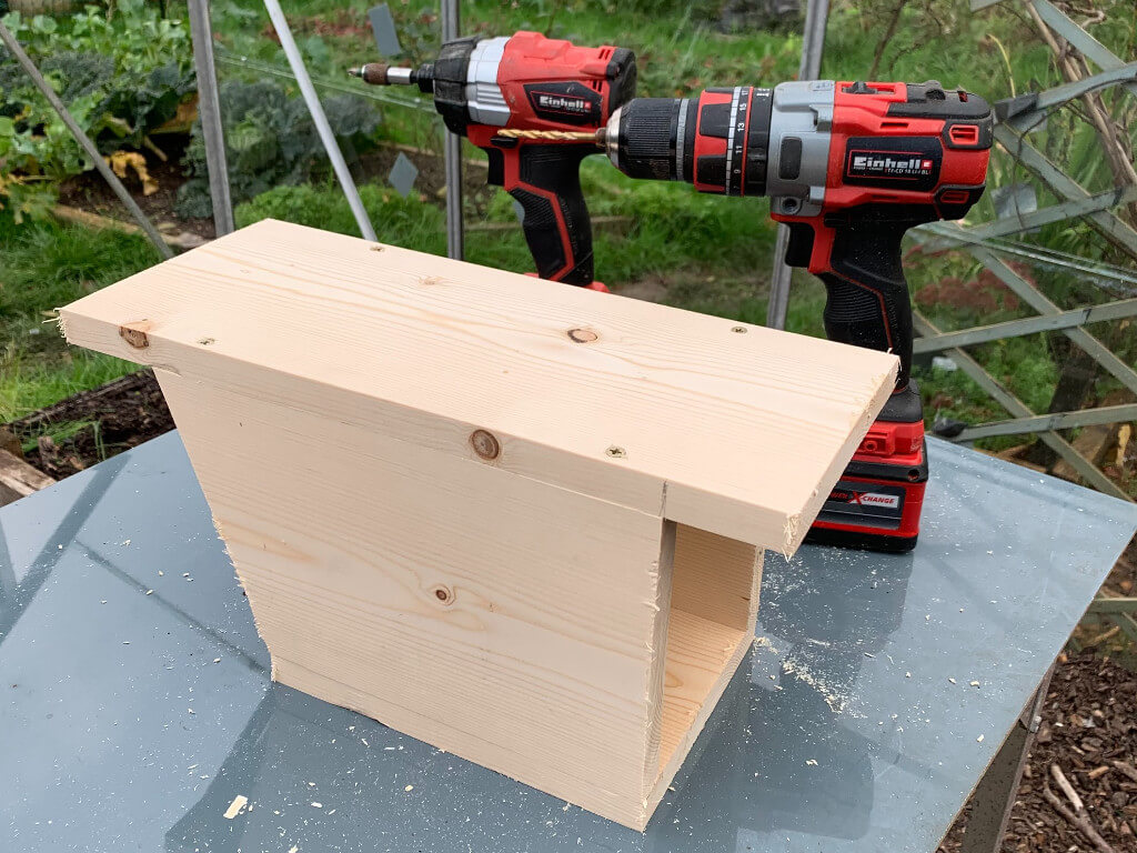 Outside image of the bird box getting the wall attached.