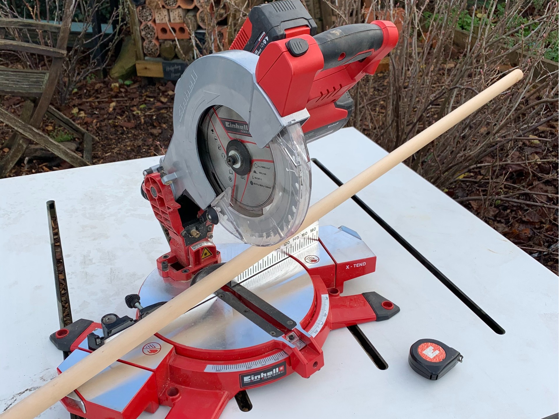 Mitre saw cutting a wood piece in half.