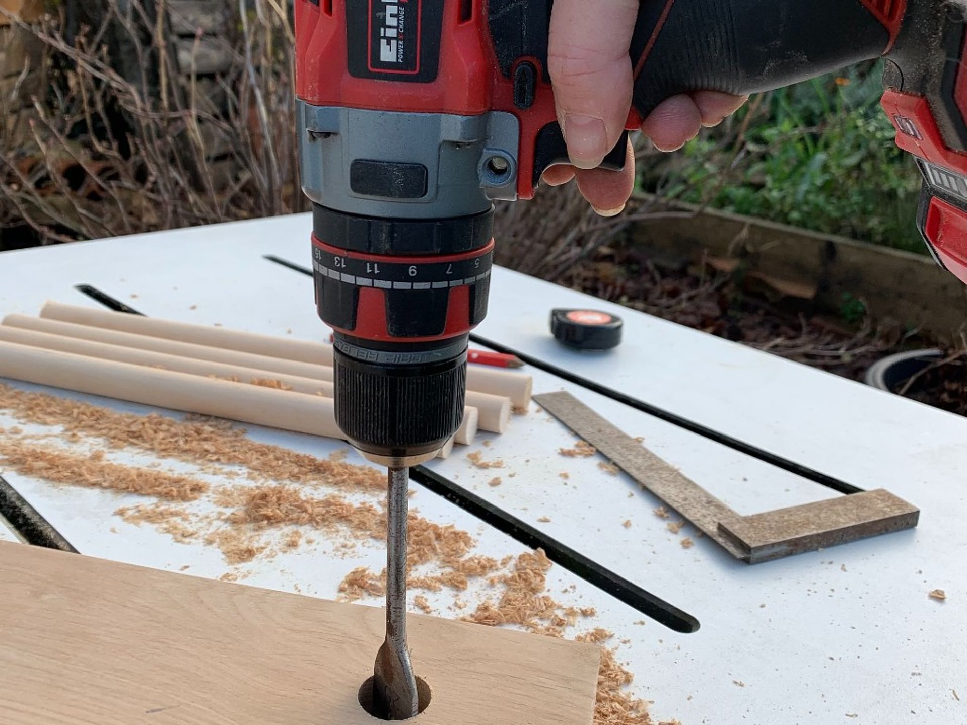 Carving a hole into a wood piece. 