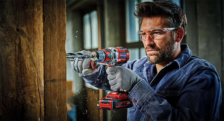 A man is screwing with a Einhell cordless screwdriver