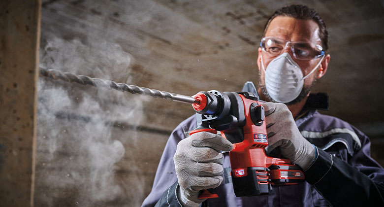 a man is workting with a Einhell cordless rotary hammer