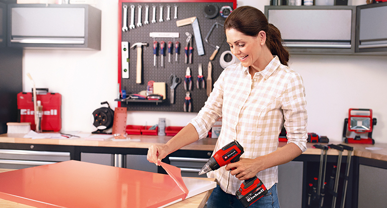 Woman using a hot air gun in a workshop